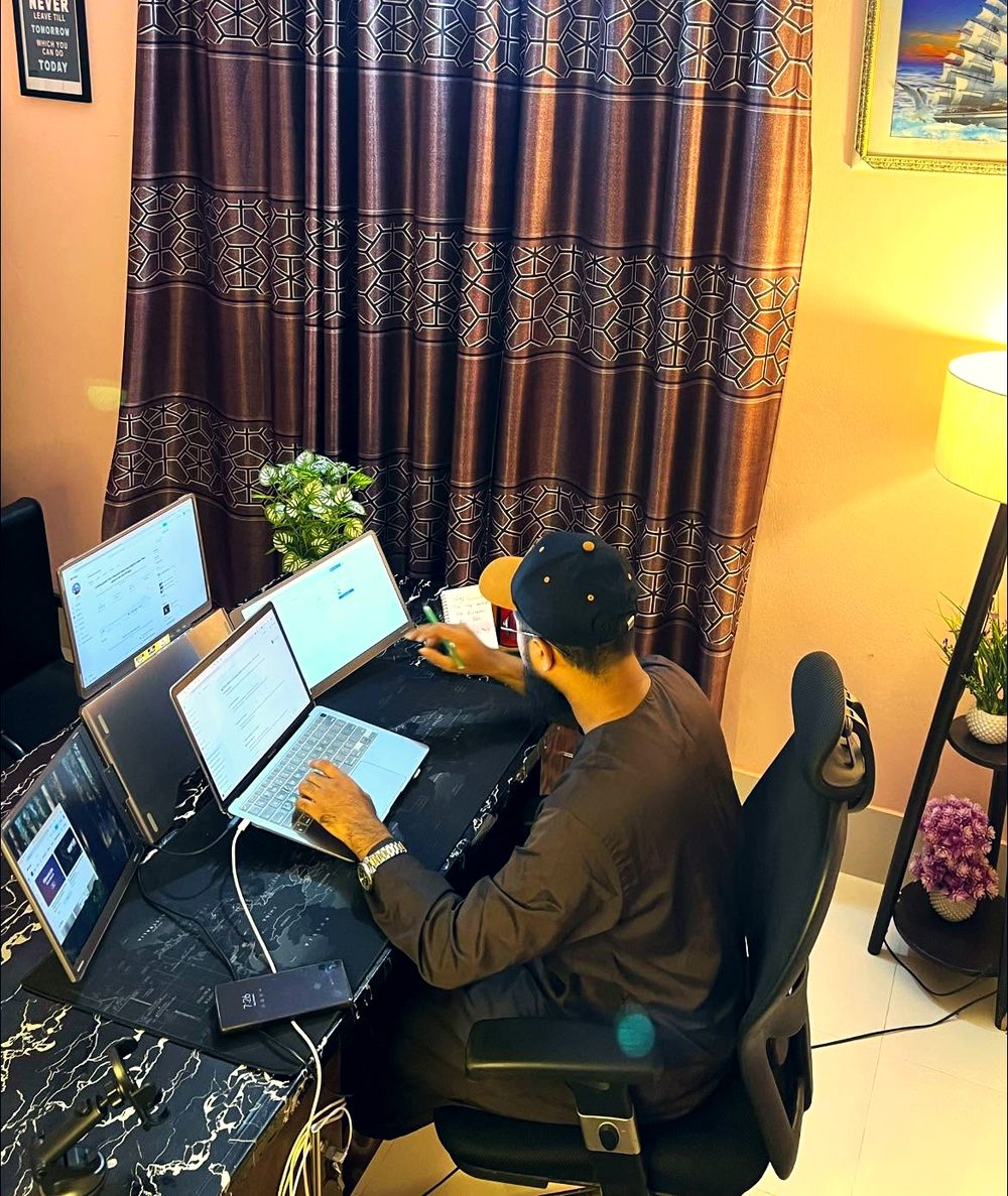 Founder working across several laptops